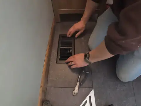 Installer setting a drain opening in tiled bathroom floor for index in Stanton for thumb loc seal beach ca 001