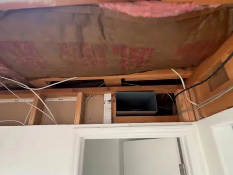 Bathroom remodel opened to studs with tub and exposed framing for index in Stanton