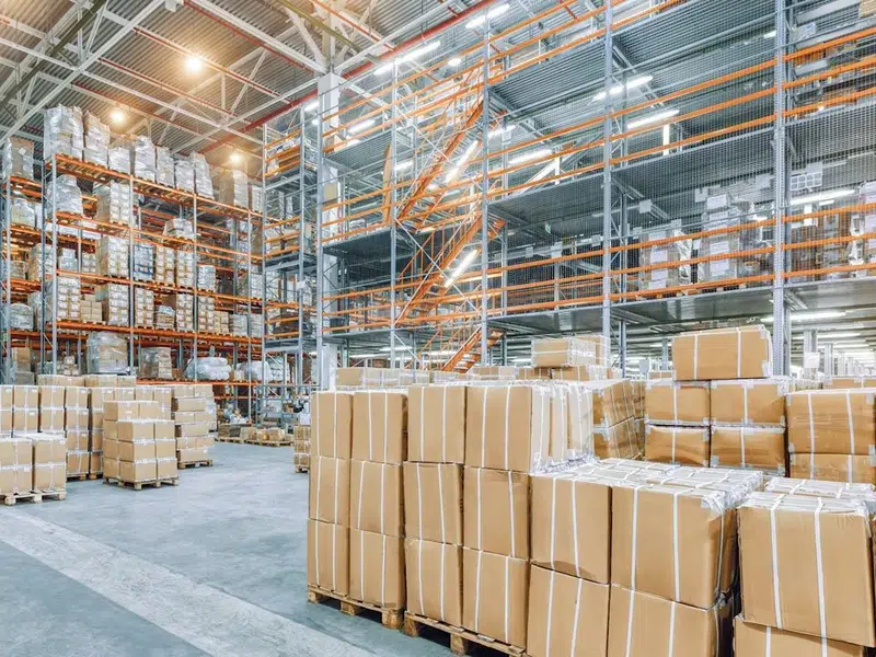 Warehouse interior with exposed overhead plumbing work for backflow testing stanton annual requirements in Stanton