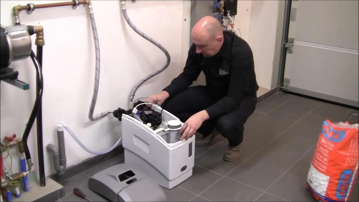 Technician setting up compact water softener unit for cypress in Cypress