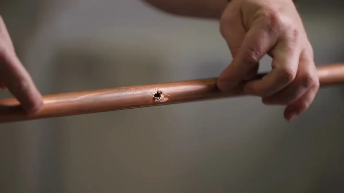 Copper pipe pinhole leak shown during pipe repair for water line repair replacement in Stanton