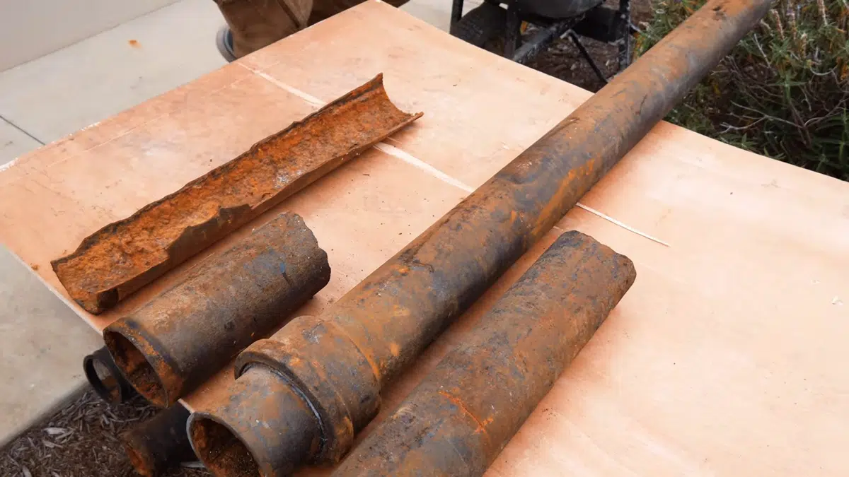 Corroded cast iron drain pipe section with heavy interior buildup for sewer line repair vs replacement orange county in Stanton