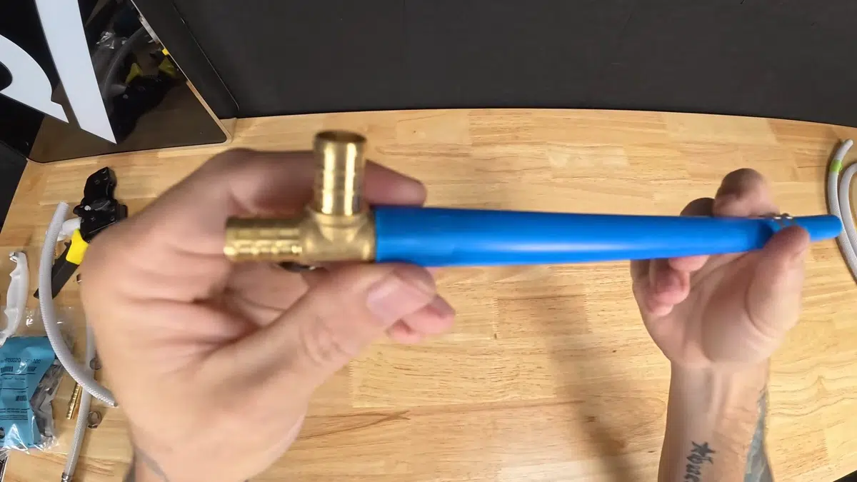 Blue flexible plumbing hose and brass fitting on table for landlord plumbing responsibilities stantonlifornia in Stanton