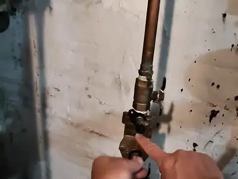 Technician connecting gas line near wall with pressure gauge nearby for index in Stanton
