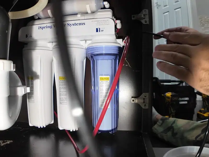 Mounted reverse osmosis filters below kitchen sink for faucet sink repair in Stanton