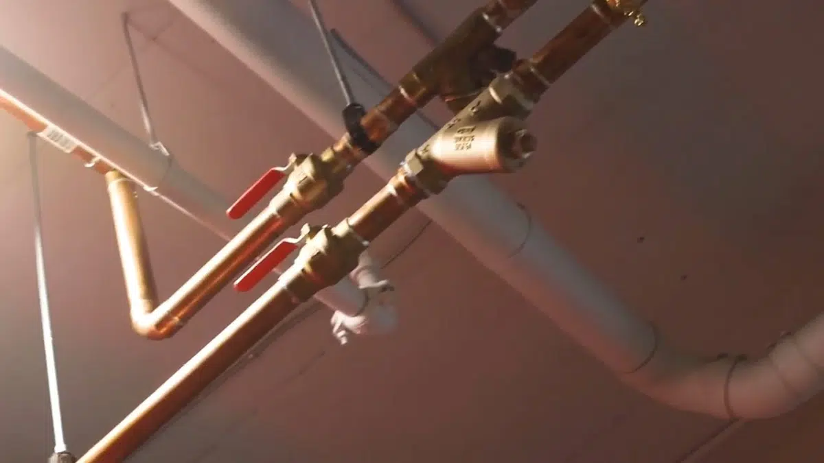 New copper and pex supply lines routed below ceiling for bathroom plumbing remodel in Stanton
