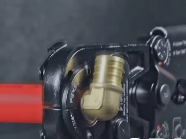 Red pipe press jaw around copper fitting for repiping in Stanton