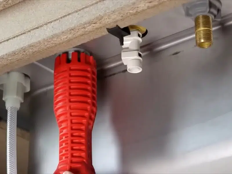 Red corrugated sleeve and pipe connections below fixture for what to do burst pipe stanton emergency guide in Stanton shown from a different service angle