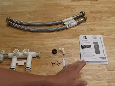 Water softener parts and hoses laid out on table for index in Stanton