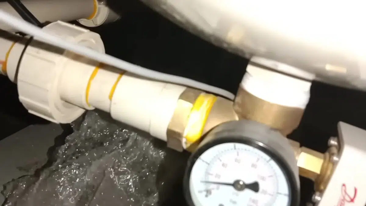 Pressure gauge and pipe fitting on softener system for signs your stanton home hasst iron drain problems in Stanton