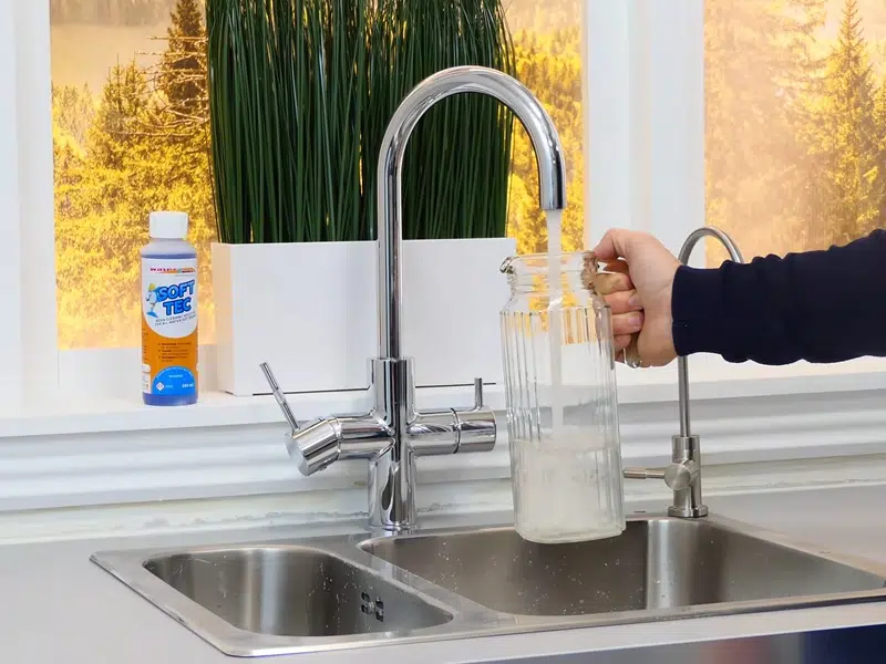 Kitchen faucet water sample for hardness testing for burst pipe repair in Stanton
