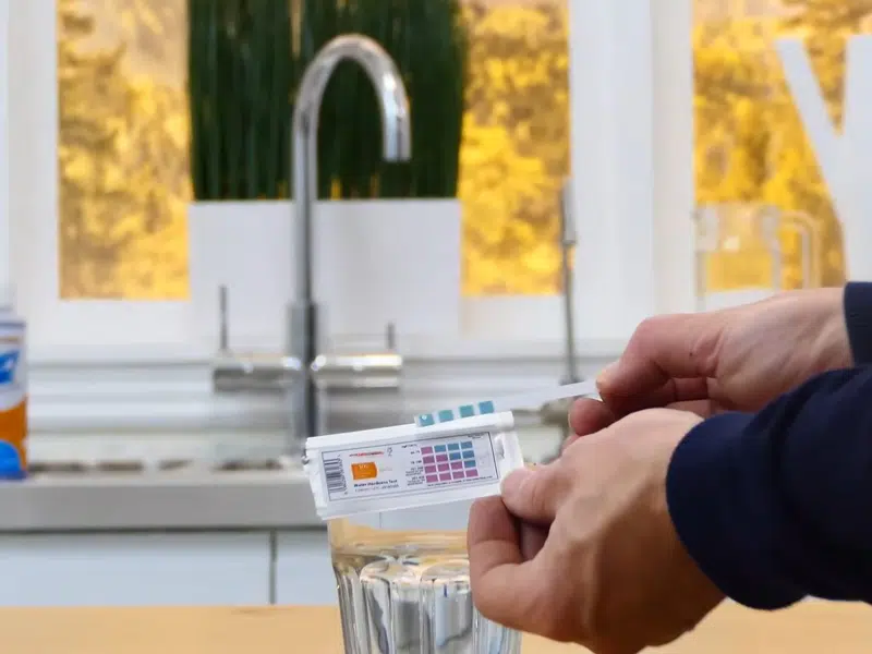 Kitchen faucet water sample for hardness testing for water softener in Stanton